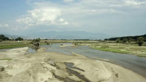 Drone shot of bridge across draining river and car passing to other side. Stock Footage 135846366