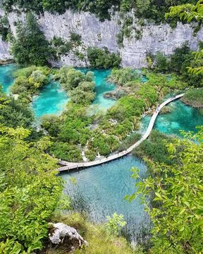Drone shot of a bridge between greenery on Plitvice Lake in the National Park Fotos Stock