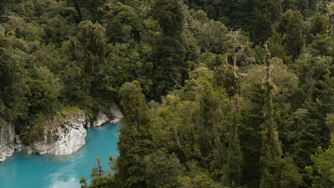 Drone shot of bridge over an alpine river surrounded by New Zealand bush Stock Footage 89995085