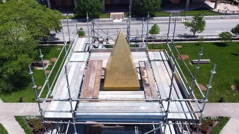 Drone shot of building in construction captured surrounded by green lawn Fotos de archivo