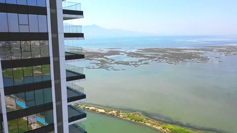 Drone shot of the building with sea view from top to bottom. Stock Footage