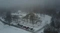 Drone shot building snow white foggy winter weather mountain forest landscape 4k or 4k+ Resolution