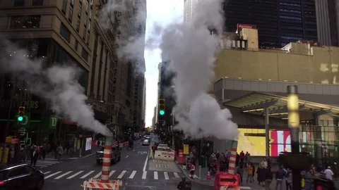 Drone shot of busy NYC New York City Manhattan street with steam during the day Stock Footage