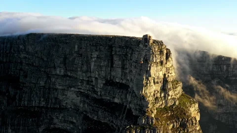 Drone shot of cable car descending from a mountain surrounded by clouds Stock Footage 170620257