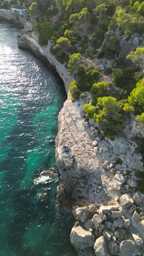 Drone shot in Cala Llombards at sunset, people jumping to water, Mallorca, Spain Stock Footage 254776681