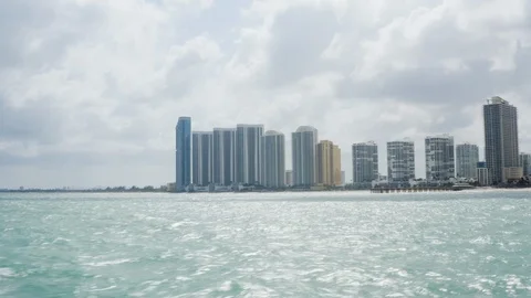 Drone shot from calm ocean of various skyscrapers by shore on Sunny Isles Beach Stock Footage 126613902