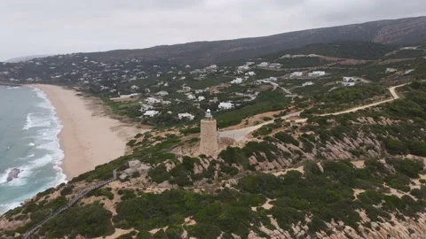 A drone shot of the Camarinal lighthouse and the Atlantic beach. Stock Footage 134670943