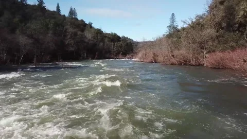 Drone shot - camera flies downstream over center of fast moving river Stock Footage 169495315