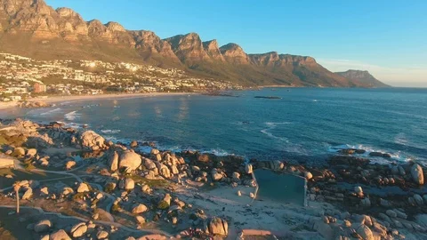 Drone shot of Camps Bay, Cape Town in South Africa with ocean and mountains. Stock Footage 85527697