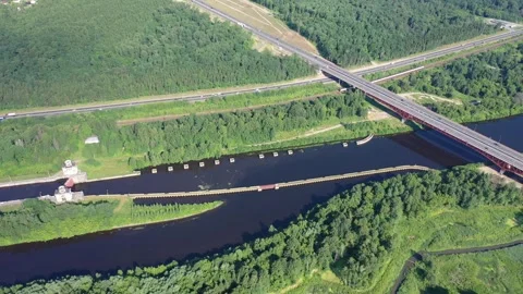Drone shot of canal lock system and forest corridor Stock Footage 324683502