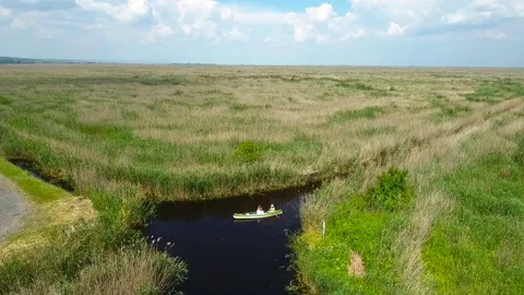 A drone shot of a canoe on a marsh Stock Footage 115641018