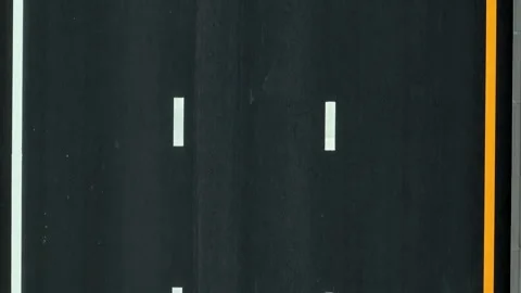 A drone shot captures a car driving on fresh asphalt. Stock Footage 320594524