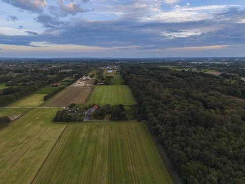 Drone shot captures countryside with patchwork fields and wooded area Foto stock