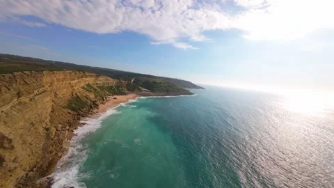 Drone shot captures dramatic cliffside ocean scene with sparkling water Stock Footage 340224872
