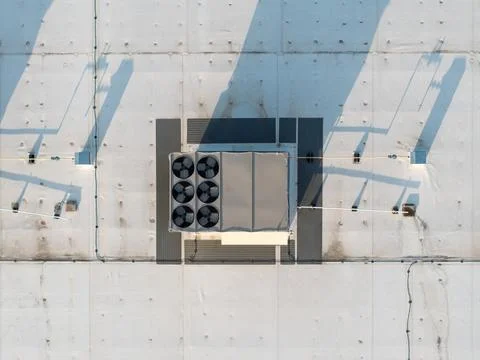 Drone shot captures an HVAC unit on a concrete roof Stock Photos