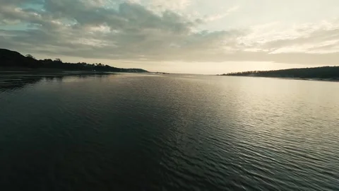 Drone shot captures tranquil lake at dusk with gentle ripples Stock Footage 340227625