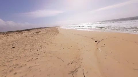 Drone shot captures tranquil shoreline, soft sand, and ocean breeze Stock Footage 345060952