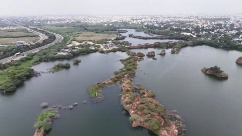 Drone shot capturing the abandoned granite quarry, where deep freshwater lakes Stockbeeldmateriaal 339159543