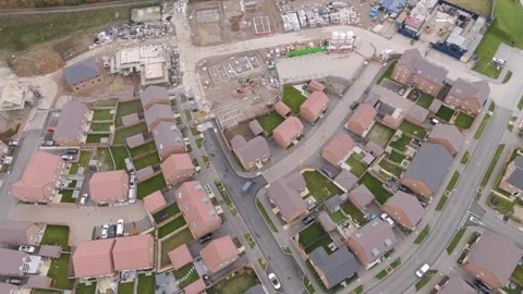 Drone shot capturing an Amazon delivery van outside a newly constructed Stock Footage 294176288