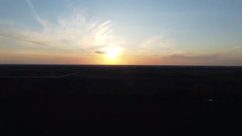 Drone shot capturing a breathtaking sunset over open fields from above. Stock Footage 300682924