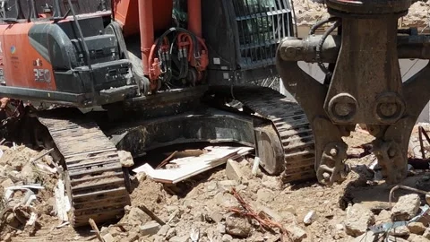 Drone shot capturing the destruction of a building by a massive bulldozer Stock Footage 294261832