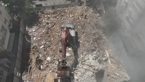 Drone shot capturing the destruction of a building by a massive bulldozer Video stock 294261855