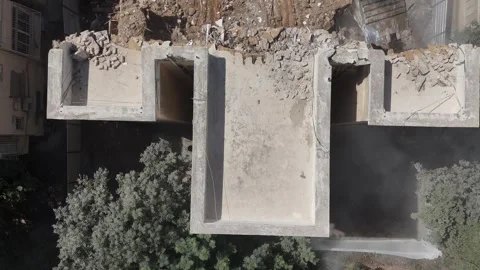 Drone shot capturing the destruction of a building by a massive bulldozer Stock Footage 294723124