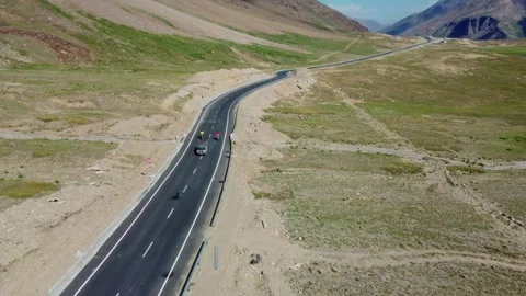 Drone shot capturing the raw beauty and vehicle movement near Penzi La’s Stock Footage 311161887