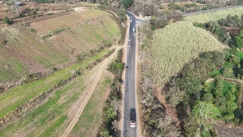 Drone shot capturing a steep hillside road featuring a cargo truck maneuvering Stock Footage 336034410