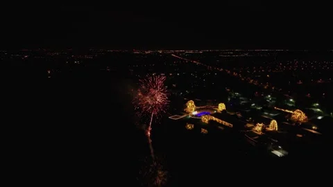 Drone shot capturing vibrant fireworks during a festive nighttime event as the Stock Footage 334668431