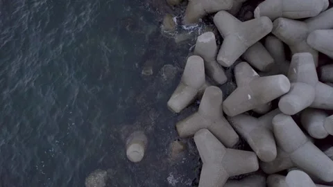 Drone Shot Capturing Waves at a Seaside Breakwater Stock Footage 252238501