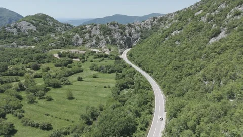 Drone Shot of Car Approaching Tunnel on Mountain Road in Montenegro Stock Footage 310335454