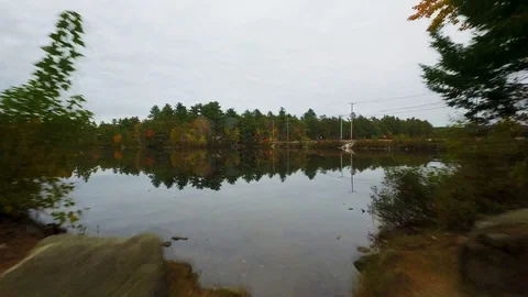 Drone shot of car on bridge going over lake in Maine 스톡 동영상 120140530