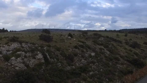 Drone shot of a car driving down the asphalt road at the top of a mountain with Видео 108618504