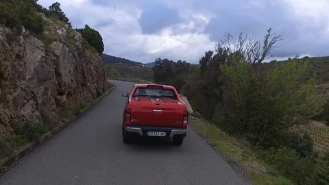 Drone shot of a car driving down the asphalt road on a mountain with mountains Stock Footage 108620208