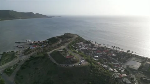 Drone shot of castle overlooking bay during sunset, Isla Margarita, Venezuela Stock Footage 261020724