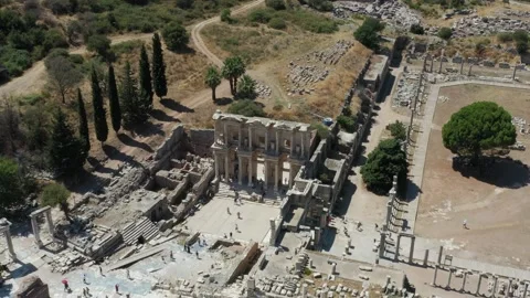 Drone shot, Celcus Library in Ephesus Historic Site While Tourists Walk By 4k Stock Footage 208029323
