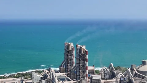 Drone shot of a cement complex near ocean for manufacturing technology Stock Footage 340247571