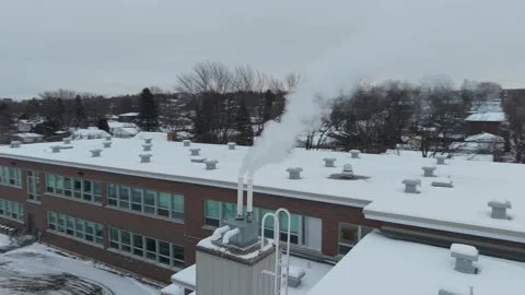 Drone shot of a chimney during winter in Canada Stock Footage 322923883