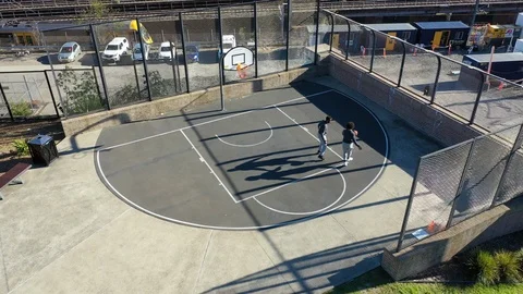 Drone Shot Circles Around Two Basketball Players Stock Footage