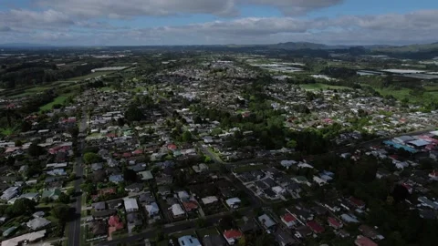 Drone shot of cityscape of Te Puke in New Zealand surrounded in greenery during Stock Footage 300871058
