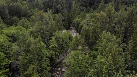 Drone shot of clear river stream flowing between rocks Stock Footage 120269619