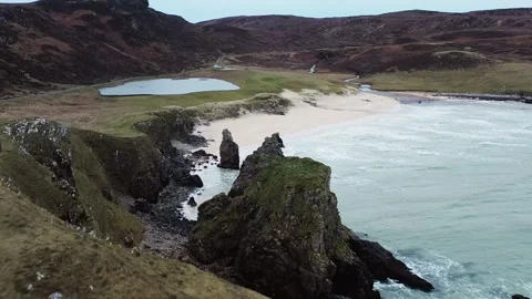 Drone shot of the cliffs and sea stacks around Garry Beach on the Outer Hebrides Stock Footage 327532503