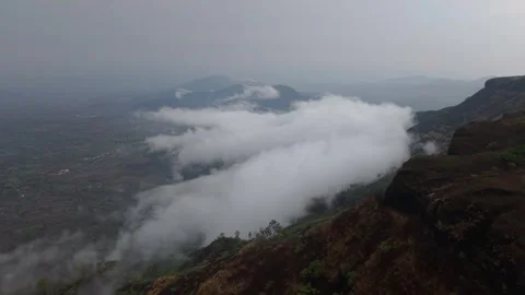 Drone shot of clouds clashing against a mountain 4K30 库存影片 332893235