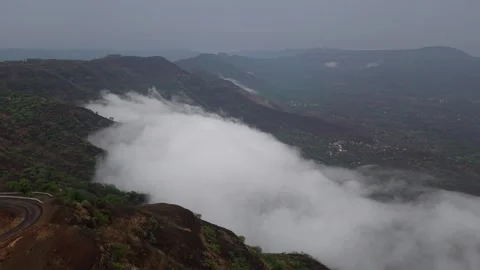 Drone shot of clouds clashing against a mountain 4K30 스톡 동영상 332893250