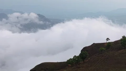 Drone shot of clouds clashing against a mountain 4K30 스톡 동영상 332893262