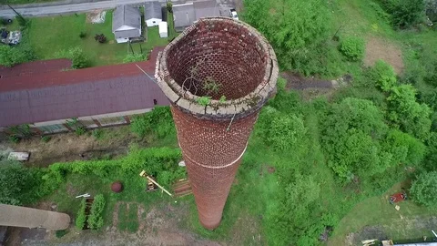 Drone shot of coal stacks and then fly over of a building Stock Footage 70602915