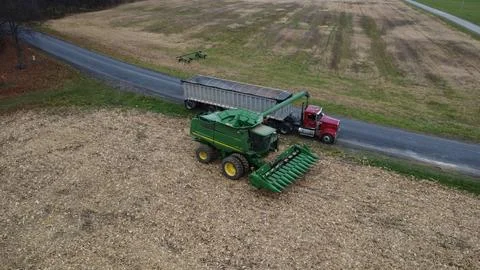 Drone shot of combine unloading corn into truck Stock Photos