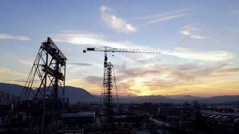 Drone shot of a Construction site on the Sunset.  Tower crane Stock Footage 106476690