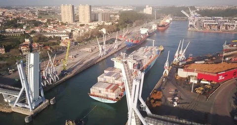 Drone shot of container ship passing through folding bridge in the river Stock Footage 114854498